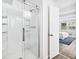 Bathroom featuring a glass enclosed walk-in shower and access to main bedroom at 1523 Vancouver Dr, Tucker, GA 30084