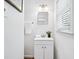 Bathroom featuring white vanity, modern fixtures, art, and a sunlit window with blinds at 1523 Vancouver Dr, Tucker, GA 30084