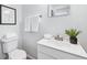 Bright bathroom with a white toilet, sink and framed art at 1523 Vancouver Dr, Tucker, GA 30084