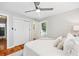 Bedroom featuring white walls, a ceiling fan, and a glimpse into the closet and hallway at 1523 Vancouver Dr, Tucker, GA 30084