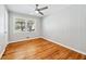 Bedroom with wood paneled wall, hardwood floors, and a window for natural light at 1523 Vancouver Dr, Tucker, GA 30084