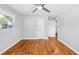 Bright bedroom with neutral walls, hardwood floors, a ceiling fan, and two doorways at 1523 Vancouver Dr, Tucker, GA 30084