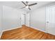 Sunny bedroom featuring wood floors, paneled walls, and a ceiling fan at 1523 Vancouver Dr, Tucker, GA 30084