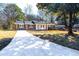 Cozy brick home with a well-manicured lawn, front porch, and new concrete driveway at 1523 Vancouver Dr, Tucker, GA 30084