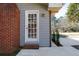 Close-up of the rear entrance featuring brick accents and muted siding at 1523 Vancouver Dr, Tucker, GA 30084