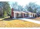 Charming single-story home with a brick facade and a well-manicured lawn and driveway at 1523 Vancouver Dr, Tucker, GA 30084