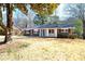 Beautiful brick home with mature trees, blue front door, and well-manicured lawn at 1523 Vancouver Dr, Tucker, GA 30084