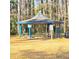 Community gazebo featuring picnic tables and a shade structure, set in a wooded area at 1523 Vancouver Dr, Tucker, GA 30084