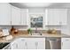 Kitchen features granite countertops, stainless steel appliances and ample natural light at 1523 Vancouver Dr, Tucker, GA 30084
