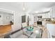Bright eat-in kitchen featuring stainless steel appliances, white cabinetry and glass-top dining table at 1523 Vancouver Dr, Tucker, GA 30084