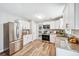 Kitchen features stainless steel appliances, granite countertops and new wood-look flooring at 1523 Vancouver Dr, Tucker, GA 30084