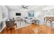 Bright living room featuring hardwood floors, a ceiling fan, and modern decor at 1523 Vancouver Dr, Tucker, GA 30084