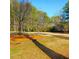 Community playground area with swing set and wood chip groundcover, bordered by mature trees at 1523 Vancouver Dr, Tucker, GA 30084