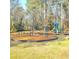 A vibrant playground with swings and climbing equipment is surrounded by a soft landing of wood chips at 1523 Vancouver Dr, Tucker, GA 30084