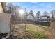 View of the backyard showcasing the grassy space, fence, and neighboring houses at 2302 Abner Nw Pl, Atlanta, GA 30318