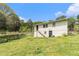 Backyard with the home in the background showing the multi-tiered yard and upper-level entry at 2302 Abner Nw Pl, Atlanta, GA 30318