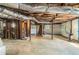 Spacious unfinished basement with concrete floor, exposed ceiling pipes, and wooden support beams at 2302 Abner Nw Pl, Atlanta, GA 30318