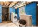 Basement laundry area with bright blue painted walls, washer, dryer, and one window at 2302 Abner Nw Pl, Atlanta, GA 30318