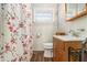 Cozy bathroom with tiled walls, new faucet, and floral shower curtain at 2302 Abner Nw Pl, Atlanta, GA 30318