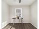 Bright bedroom with gray wood flooring, neutral walls, a ceiling fan, and a table by the window at 2302 Abner Nw Pl, Atlanta, GA 30318