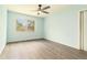 Inviting bedroom featuring laminate flooring, a ceiling fan, and plenty of natural light at 2302 Abner Nw Pl, Atlanta, GA 30318