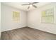 Bright bedroom with gray wood flooring, neutral walls, and two windows offering natural light at 2302 Abner Nw Pl, Atlanta, GA 30318