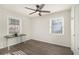Bright bedroom with gray wood flooring, neutral walls, a ceiling fan, and two windows offering natural light at 2302 Abner Nw Pl, Atlanta, GA 30318
