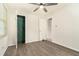 Bright bedroom with gray wood flooring, neutral walls, and a door to another room at 2302 Abner Nw Pl, Atlanta, GA 30318