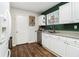 Bright kitchen with white cabinets, stainless steel dishwasher, and wood-look flooring at 2302 Abner Nw Pl, Atlanta, GA 30318
