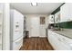 Kitchen with white cabinets and stainless steel appliances and wood-look flooring at 2302 Abner Nw Pl, Atlanta, GA 30318