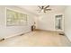 Spacious living room with carpeted floors, neutral walls, a ceiling fan, and a door to another room at 2302 Abner Nw Pl, Atlanta, GA 30318