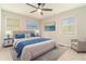 Bedroom with large windows, a ceiling fan, grey walls, light carpet, and gray bedding at 2302 Abner Nw Pl, Atlanta, GA 30318