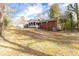 Sloping backyard with a sunroom and partial view of the home's exterior at 7278 Selkirk Dr, Atlanta, GA 30328