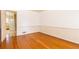 Dining room with hardwood floors and neutral paint leading to a doorway to the kitchen at 7278 Selkirk Dr, Atlanta, GA 30328