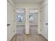 Hallway view into two bedrooms, showing neutral carpet and double windows with blinds at 2240 Mulsanne Dr, Lithonia, GA 30058