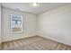 Neutral bedroom with carpet, white walls, and a window with blinds allowing natural light at 2240 Mulsanne Dr, Lithonia, GA 30058