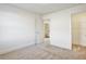 Bedroom with white walls and carpet with an open bathroom and walk-in closet at 2240 Mulsanne Dr, Lithonia, GA 30058