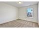 Bedroom with neutral colored walls and carpet with natural light through the window at 2240 Mulsanne Dr, Lithonia, GA 30058