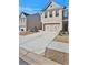 Charming two-story townhome with a neutral brick facade and attached two-car garage at 2240 Mulsanne Dr, Lithonia, GA 30058