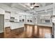 Bright living room featuring hardwood floors, modern ceiling fan, and an island kitchen at 2240 Mulsanne Dr, Lithonia, GA 30058