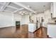 Spacious living room featuring a modern kitchen, hardwood floors, fireplace, and coffered ceiling at 2240 Mulsanne Dr, Lithonia, GA 30058