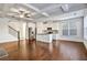 Open-concept living space with a modern kitchen, hardwood floors, coffered ceiling, and a staircase at 2240 Mulsanne Dr, Lithonia, GA 30058