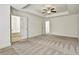 Bright main bedroom with ceiling fan, carpet and an ensuite bath with soaking tub at 2240 Mulsanne Dr, Lithonia, GA 30058