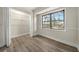 Bedroom featuring hardwood floors, a closet with shelving, and a window overlooking the backyard at 3385 Lyndale St, Douglasville, GA 30135