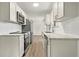 Bright kitchen featuring white cabinets, stainless steel appliances, and granite countertops at 3385 Lyndale St, Douglasville, GA 30135