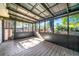 Enclosed sunroom featuring wood flooring, screened walls, and a metal grid roof providing a relaxing outdoor space at 3385 Lyndale St, Douglasville, GA 30135