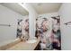 Bright bathroom featuring a marble shower curtain, granite countertop, and well-lit mirror, creating a stylish and functional space at 599 Jefferson Chase St, Atlanta, GA 30354