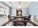 Dining room with wainscoting, tray ceiling, and rustic wood furniture at 599 Jefferson Chase St, Atlanta, GA 30354