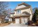 Lovely tan two story home with a two car garage and well manicured landscaping at 599 Jefferson Chase St, Atlanta, GA 30354