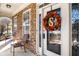 Inviting front porch with stone accents, chairs, and a decorative wreath on the front door at 599 Jefferson Chase St, Atlanta, GA 30354